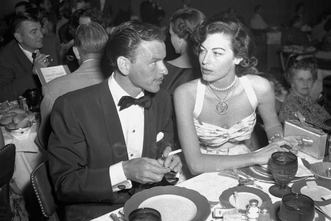 FILE - In this Aug. 19, 1951 file photo, singer Frank Sinatra and Ava Gardner hold cigarettes as they dine together at the Riverside Hotel in Reno, Nev. On Jan. 11, 1964, U.S. Surgeon General Luther Terry released an emphatic and authoritative report that said smoking causes illness and death - and the government should do something about it. (AP Photo)