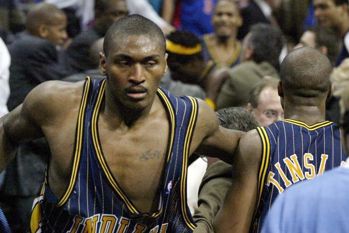 FILE - In this Nov. 19, 2004, file photo, Indiana Pacers forward Ron Artest gets back on the court after going into the stands after fans during a brawl with the Detroit Pistons with just 45.9 seconds left in an NBA basketball game in Auburn Hills, Mich. Artest was suspended for 72 games, the longest Commissioner David Stern ever handed out for an on-court punishment. (AP Photo/Duane Burleson, File)