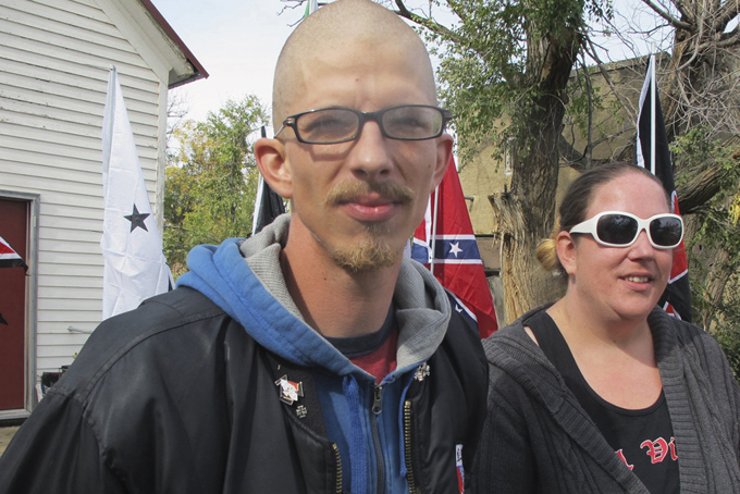 This Oct. 9, 2013 file photo, shows White supremacist Kynan Dutton, left, and Debra Henderson in front of the home owned by White supremacist Craig Cobb in Leith, N.D. (AP Photo/Bismarck Tribune, Lauren Donovan, File)