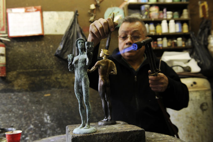 Joaquin Quintero uses a blowtorch as a patina is applied to the solid bronze Actor, the Screen Actors Guild Award, on Thursday, Jan. 9, 2014, in Burbank, Calif. The Screen Actors Guild will be held on Sunday, Jan. 18, in Los Angeles. (Photo by Chris Pizzello/Invision/AP)