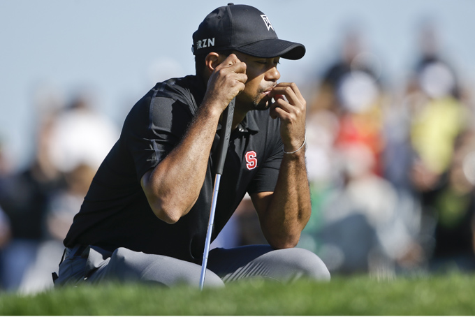 Tiger Woods waits his turn on the second green of the South Course at Torrey Pines during the third round of the Farmers Insurance Open golf tournament Saturday, Jan. 25, 2014, in San Diego. (AP Photo/Lenny Ignelzi)