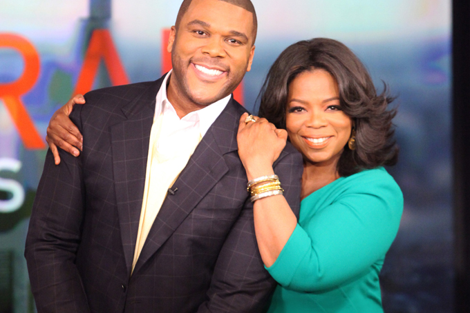 This photo released by Harpo Studios shows Tyler Perry, left, and Oprah Winfrey, during the show, "Oprah Fridays Live." (AP PhotoHarpo Inc., George Burns)