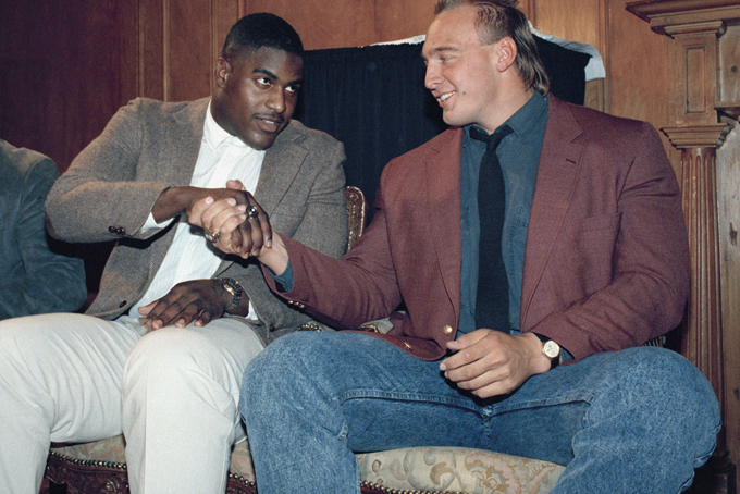 In this Dec. 7, 1988, file photo, Auburn's Tracy Rocker, center, the winner of the 1988 Outland Trophy, gets a congratulatory handshake from runner-up Tony Mandarich, right, of Michigan State, at a ceremony in New York. (AP Photo/Adam Stoltman, File)