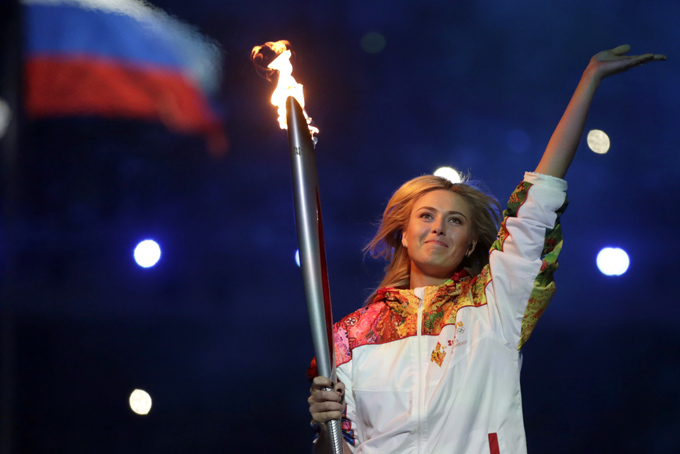 Russia's Maria Sharapova carries the torch during the opening ceremony of the 2014 Winter Olympics in Sochi, Russia, Friday, Feb. 7, 2014. (AP Photo/Matt Dunham)