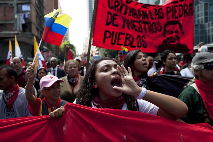 Members of a pro-government "colectivo," or "collective," march in downtown Caracas, Venezuela, Thursday, Feb. 20, 2014. (AP Photo/Rodrigo Abd)