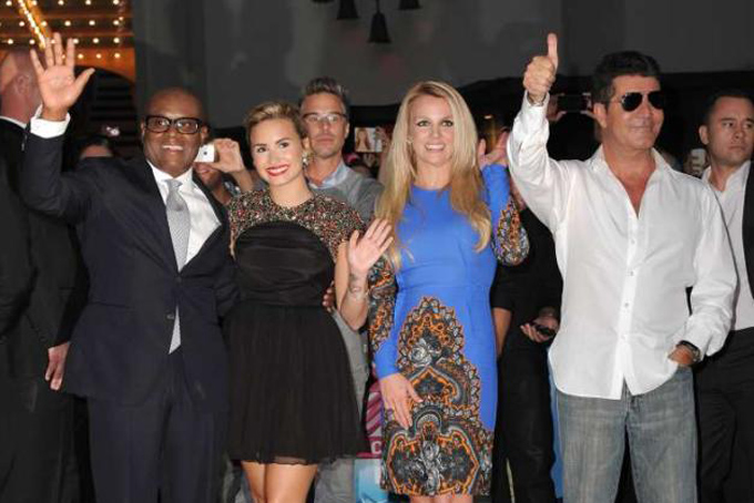 'X Factor' judges L.A. Reid, Demi Lovato, Britney Spears and Simon Cowell wave to fans.(Jordan Strauss/JORDAN STRAUSS/INVISION/AP)