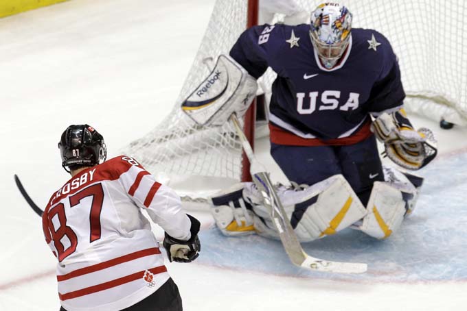 In a Feb. 28, 2010 file photo Canada's Sidney Crosby (87) shoots past USA goalie Ryan Miller (39) for the game-winning goal in the overtime period of a men's gold medal ice hockey game at the Vancouver 2010 Olympics in Vancouver, British Columbia. Crosby will captain the Canadian hockey team at the Olympics in Sochi. (AP Photo/Chris O'Meara, file)