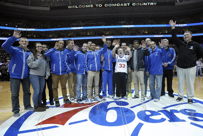 Kevin Grow (33) poses for a team photo with his Bensalem high school basketball team during a time out in a game between the Philadelphia 76ers and the Cleveland Cavaliers on Tuesday, Feb. 18, 2014, in Philadelphia. Kevin has been signed by the Philadelphia 76ers to a ceremonial two-day contract. (AP Photo/Michael Perez)