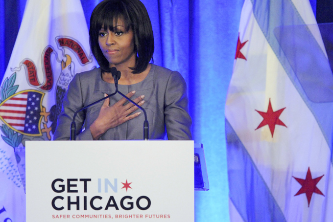 FILE - In this April 10, 2013 file photo, first lady Michelle Obama speaks at a luncheon in Chicago about the death of 15-year-old Hadiya Pendleton who was shot and killed Jan. 29, 2013 in a park during a gang dispute she had nothing to do with about a mile from the first family's Chicago home. The low point so far in Chicago’s closely watched battle with street gangs may have been the day Feb. 9, 2013, when the first lady came home for Hadiya's funeral. Since Pendleton's death, the number of homicides and other violent crimes that turned Chicago into a national symbol of gun violence have fallen sharply after the city and police changed strategies. (AP Photo/Paul Beaty, File)
