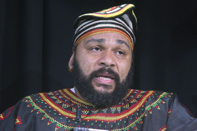 In this Saturday, Jan. 11, 2014 file photo, French comic Dieudonne M'Bala M'Bala speaks to the media during a press conference in a theater in Paris. (AP Photo/Michel Euler, file)