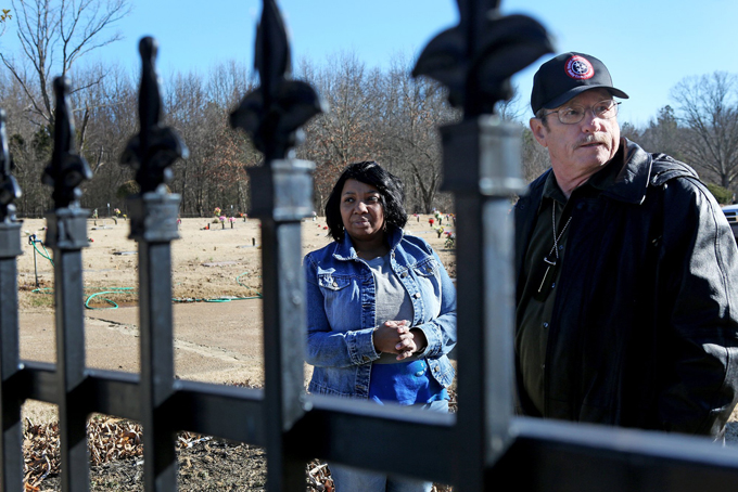 Mariam Woody speaks with James E. Johnston, Jr., a criminal investigator, Shelby County District Attorney General Office, as she tries to visit her brother's grave at Galilee Memorial Gardens in Bartlett, Tenn. Friday, Jan 24, 2014. (AP Photo/The Commercial Appeal, Yalonda M. James)