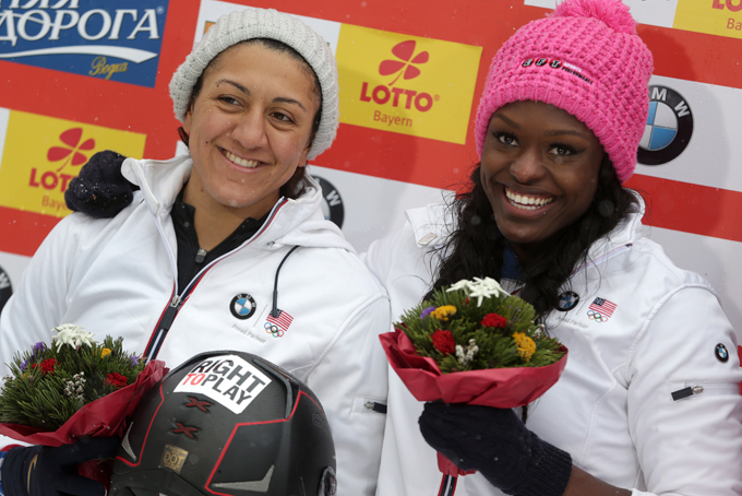 Elana Meyers, left, and Aja Evans of the United States celebrate their second place at the two-woman Bobsled World Cup race in Koenigssee, southern Germany, on Sunday, Jan. 26, 2014. (AP Photo/Matthias Schrader)