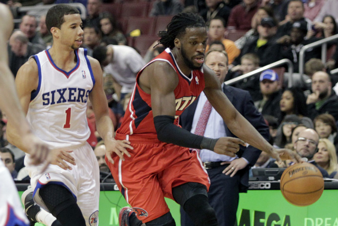 Atlanta Hawks' DeMarre Carroll, right, moves the ball up court as Philadelphia 76ers' Michael Carter-Williams (1) defends in the first half of an NBA basketball game, Friday, Jan. 31, 2014, in Philadelphia. The Hawks won 125-99. (AP Photo/H. Rumph Jr.)