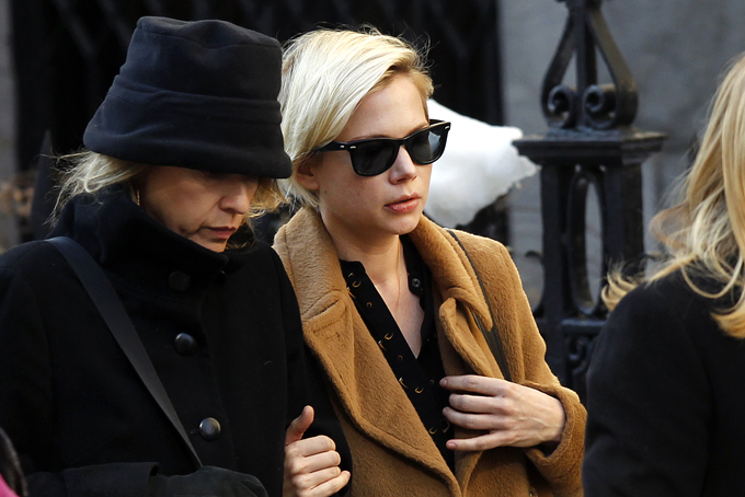 Actress Michelle Williams, right, arrives at the Church of St. Ignatius Loyola for the private funeral of actor Philip Seymour Hoffman Friday, Feb. 7, 2014, in New York. Hoffman, 46, was found dead Sunday of an apparent heroin overdose. (AP Photo/Jason DeCrow)