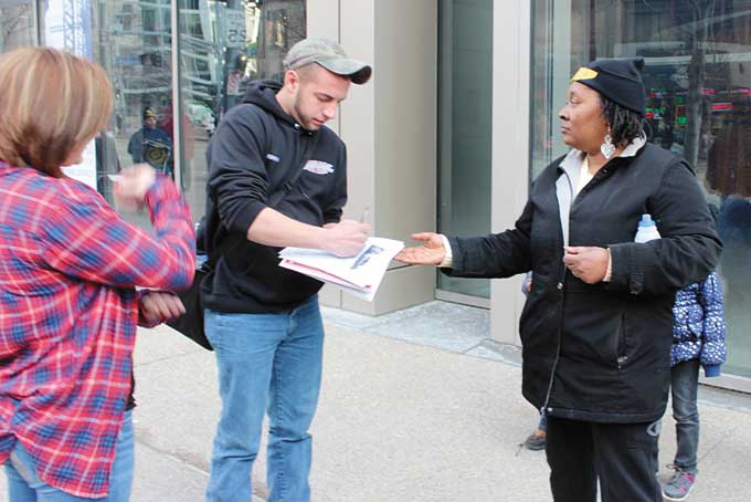 GET IN THE GAME—Renee Gray and supporters ask passers-by to sign a petition to keep the foreclosed August Wilson Center for African American Culture open.