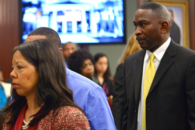 Lucia McBath, left and Ronald Davis, right, parents of Jordan Davis, walk out of the courtroom during the trial of Michael Dunn in Jacksonville, Fla., Tuesday Feb. 11, 2014. (The Florida Times-Union, Bob Mack, Pool)