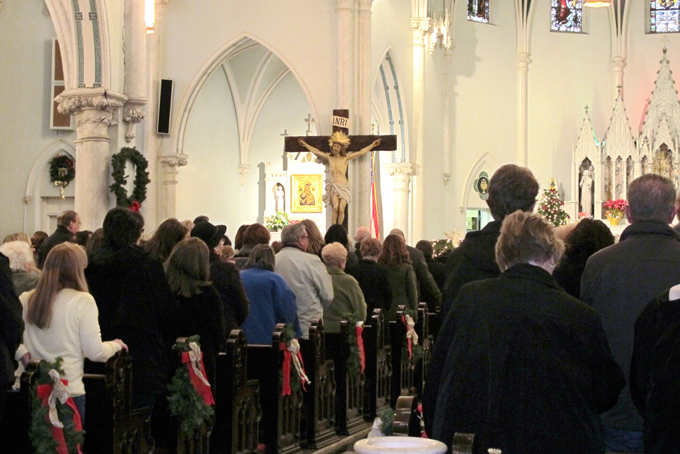 This Jan. 12, 2014 photo shows people gathered for mass inside Our Lady of Perpetual Help Church in Buffalo, N.Y., during a “Mass Mob.” Borrowed from the idea of flash mobs, Mass Mobs encourage crowds to attend Mass at a specified church on a certain day to fill pews, lift spirits and help financially some of the city’s oldest but often sparsely attended churches. (AP Photo/Carolyn Thompson)