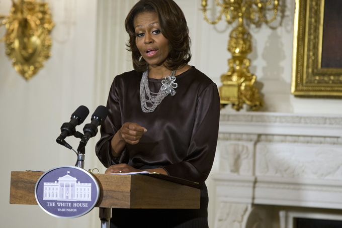 In this Jan. 15, 2014 file photo, first lady Michelle Obama speaks in the State Dining Room of the White House in Washington. Michelle Obama turned 50 on Friday and promptly showed off her AARP card. (AP Photo/ Evan Vucci, File)