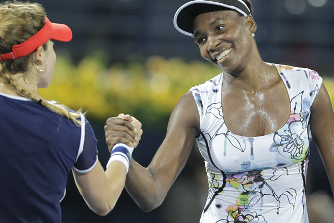 Venus Williams of the U.S. shakes hands with Alize Cornet of France after she beat her in the final match of Dubai Duty Free Tennis Championships in Dubai, United Arab Emirates, Friday, Feb. 21, 2014. (AP Photo/Kamran Jebreili)