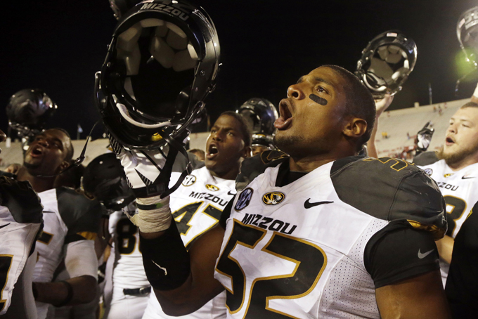 In this Sept. 21, 2013, file photo, Missouri's Michael Sam (52) sings the school song after Missouri defeated Indiana in an NCAA college football game in Bloomington, Ind. The All-American athlete says he is gay, and the defensive end could become the first openly homosexual player in the NFL. (AP Photo/Darron Cummings, File) 
