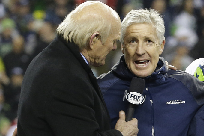 Former NFL player and sports broadcast host Terry Bradshaw interviews Seattle Seahawks head coach Pete Carroll after the NFL football NFC Championship game against the San Francisco 49ers Sunday, Jan. 19, 2014, in Seattle. The Seahawks won 23-17 to advance to Super Bowl XLVIII. (AP Photo/Ted S. Warren)