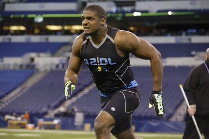  Missouri defensive lineman Michael Sam runs a drill at the NFL football scouting combine in Indianapolis, Monday, Feb. 24, 2014. (AP Photo/Michael Conroy)