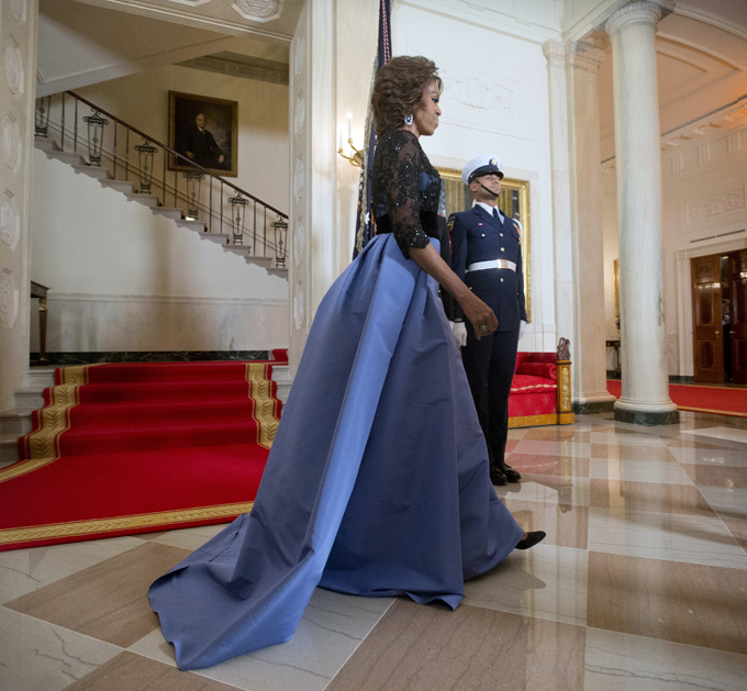 First Lady Michelle Obama walks away from the Grand Staircase after posing for the official photo with President Barack Obama with French President Francois Hollande as they arrive for a State Dinner at the White House in Washington, Tuesday, Feb. 11, 2014. (AP Photo/Pablo Martinez Monsivais)