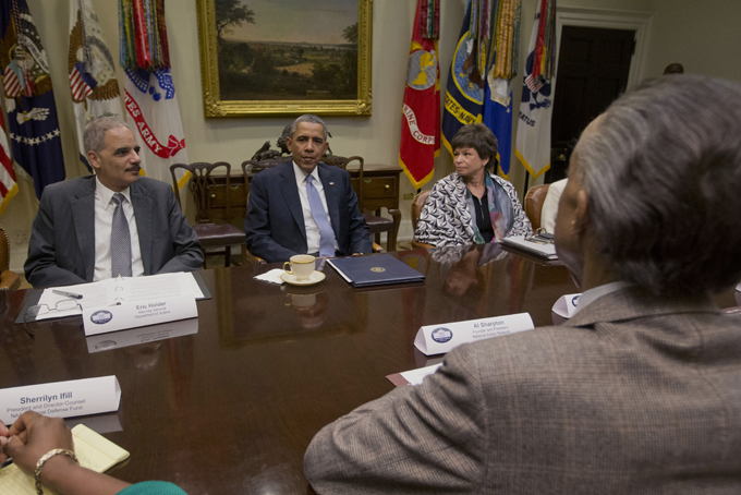President Barack Obama meets with African American Civil Rights group leaders in the Roosevelt Room of the White House in Washington, Tuesday, Feb. 18, 2014. From left are, Attorney General, Eric Holder, the president and White House Senior Adviser Valerie Jarrett. Across the table is Rev. Al Sharpton, Founder and President, National Action Network. (AP Photo/Pablo Martinez Monsivais)