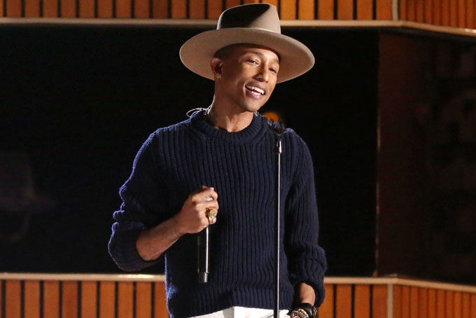 This Jan. 26, 2014 file photo shows Pharrell Williams on stage at the 56th annual Grammy Awards at Staples Center in Los Angeles. Oscars producers say in a news release Tuesday, Feb. 7, that Williams will sing his nominated song “Happy.” The Oscars will air live March 2 on ABC with Ellen DeGeneres as host. (Photo by Matt Sayles/Invision/AP, File)