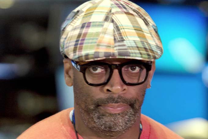  File-This July 31, 2013, file photo shows filmmaker Spike Lee being interviewed on the floor of the New York Stock Exchange. (AP Photo/Richard Drew, File)