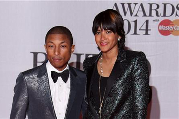 Pharrell Williams and his wife Helen Lasichanh arrive at the BRIT Awards 2014 at the O2 Arena in London on  Feb. 19. (Photo by Joel Ryan/Invision/AP)