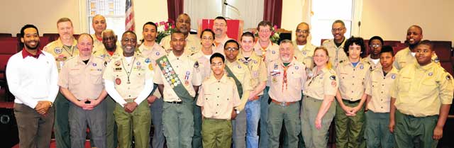 PROUD LEADER—Nathaniel Grey, with badge, stands in front of troop # 379.
