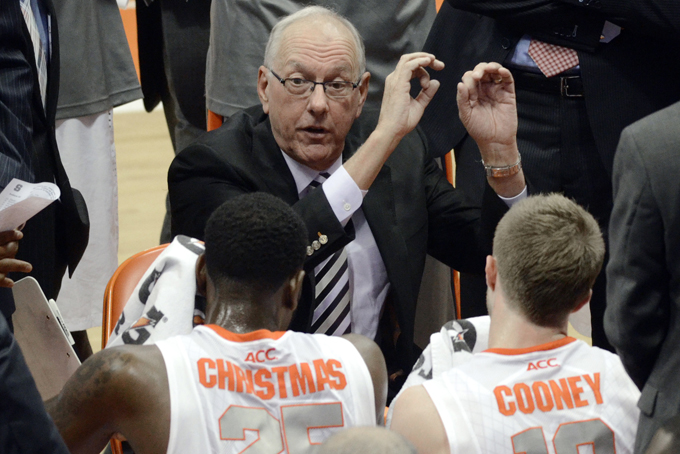  In htis Dec. 3, 2013, file photo, Syracuse head coach Jim Boeheim talks with his players during a time out against Indiana in the second half of an NCAA college basketball game in Syracuse, N.Y. Seven games stand between Syracuse and an unbeaten regular season. (AP Photo/Kevin Rivoli, File)