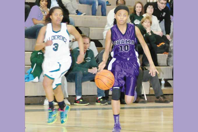 SAMONE RAINEY (10) Obama Academy's  drives by Tiara Travis (3) of Allderdice in the City League Championship game , Rainey scored 12 points for the Eagles. 