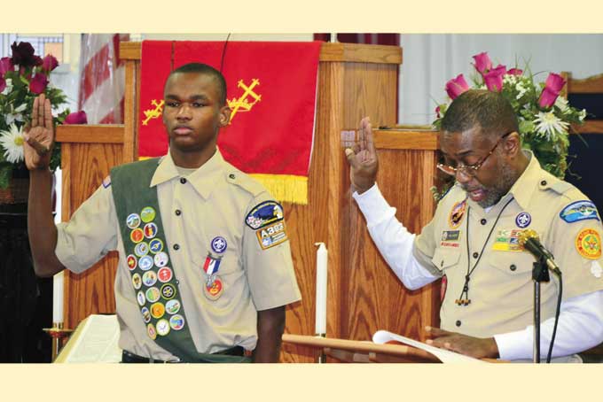 SCOUTS HONOR—Eighteen-year-old Nathaniel Stanley Grey, recites the pledge of honor with Scoutmaster Paul Harper of Troop # 379 as the newest Eagle Scout in Pittsburgh. (Photos by Rossano P. Stewart)