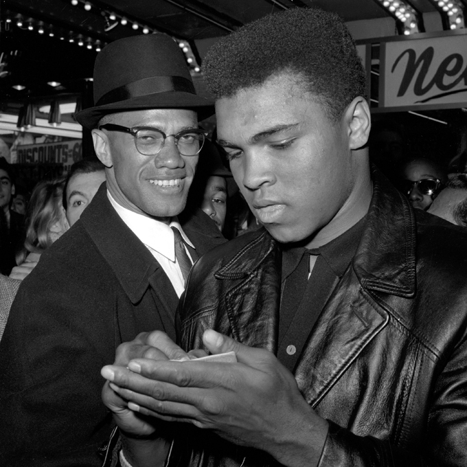 In this March 1, 1964 file photo, Muhammad Ali, world heavyweight boxing champion, right, stands with Malcolm X outside the Trans-Lux Newsreel Theater on Broadway at 49th Street in New York. They had just watched a screening of films on Ali's Feb. 25, 1964 title fight with Sonny Liston in Miami Beach. Two days after the fight with Liston, Cassius Clay announced he was a member of the Nation of Islam and was changing his name to Cassius X. He would later become Muhammad Ali as he broke away from Malcolm X and aligned himself with the sect's leader, Elijiah Muhammad. "What is all the commotion about?" he asked. "Nobody asks other people about their religion. But now that I'm the champion I am the king so it seems the world is all shook up about what I believe." (AP Photo)