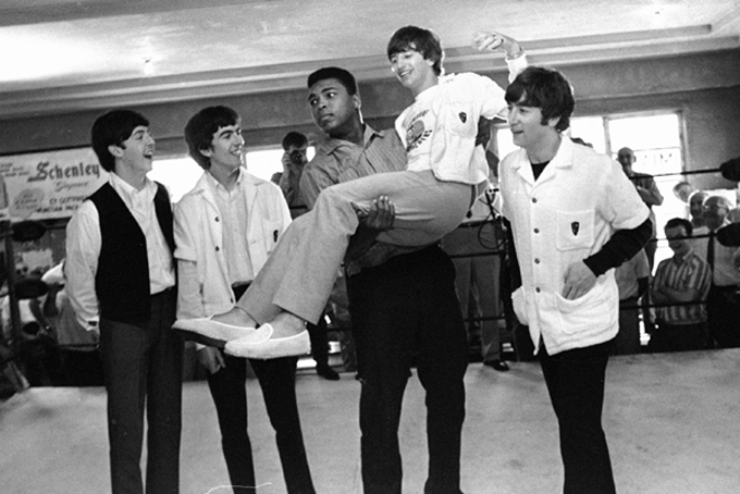 In this Feb. 18, 1964 file photo, boxer Cassius Clay lifts Beatles member Ringo Starr while the singers visited Clay's camp in Miami Beach, Fla. Others from left are Paul McCartney, George Harrison and John Lennon. (AP Photo)