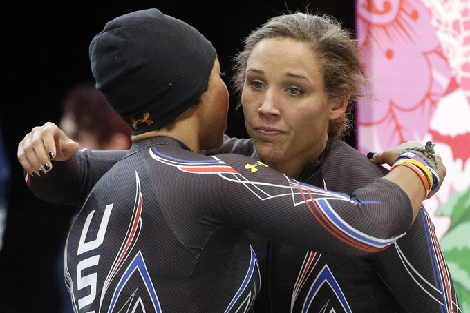 The team from the United States USA-3, pilot Jazmine Fenlator, left, and brakeman Lolo Jones, hug after their second run during the women's two-man bobsled competition at the 2014 Winter Olympics, Tuesday, Feb. 18, 2014, in Krasnaya Polyana, Russia. (AP Photo/Dita Alangkara)
