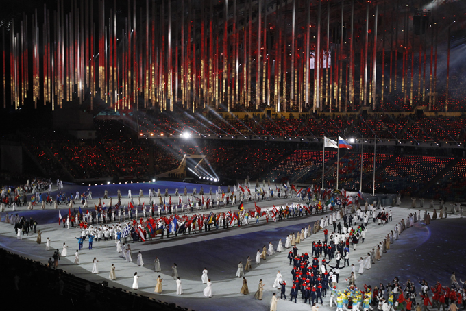 Athletes march into the arena during the closing ceremony of the 2014 Winter Olympics, Sunday, Feb. 23, 2014, in Sochi, Russia. (AP Photo/Matthias Schrader)