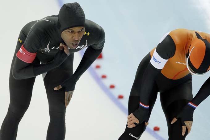 Shani Davis of the U.S., left, and Koen Verweij of the Netherlands rest after competing in the men's 1,000-meter speedskating race at the Adler Arena Skating Center during the 2014 Winter Olympics, in Sochi, Russia, Wednesday, Feb. 12, 2014. (AP Photo/Patrick Semansky)