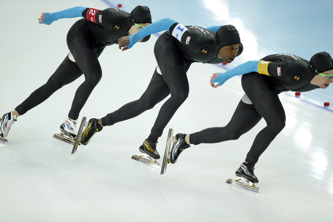 The U.S. speedskating team, left to right, Brian Hansen, Shani Davis and Jonathan Kuck compete in the men's speedskating team pursuit quarterfinals at the Adler Arena Skating Center during the 2014 Winter Olympics in Sochi, Russia, Friday, Feb. 21, 2014. (AP Photo/Pavel Golovkin)