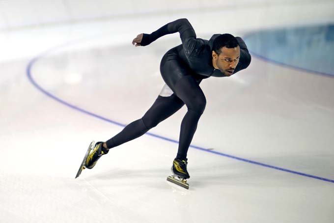 United States long track speed skater Shani Davis glides around a turn as he practices in Adler Arena for the 2014 Winter Olympics, Jan. 31,  in Sochi, Russia. (AP Photo/David Goldman)