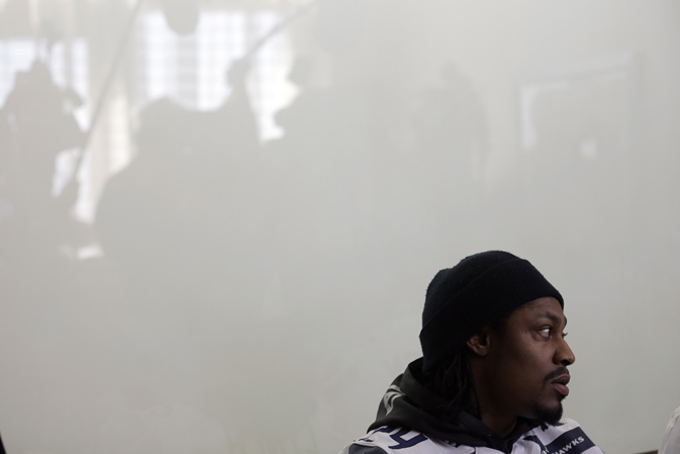 Seattle Seahawks running back Marshawn Lynch listens to a question as members of the media are reflected on a piece of glass Thursday, Jan. 30, 2014, in Jersey City, N.J. The Seahawks and the Denver Broncos are scheduled to play in the Super Bowl XLVIII football game Sunday, Feb. 2, 2014. (AP Photo)