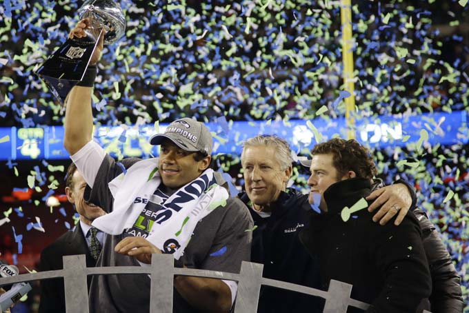 Seattle Seahawks' Russell Wilson holds the Vince Lombardi Trophy as he celebrates after the NFL Super Bowl XLVIII football game against the Denver Broncos Sunday, Feb. 2, 2014, in East Rutherford, N.J. (AP Photo/Matt Slocum)