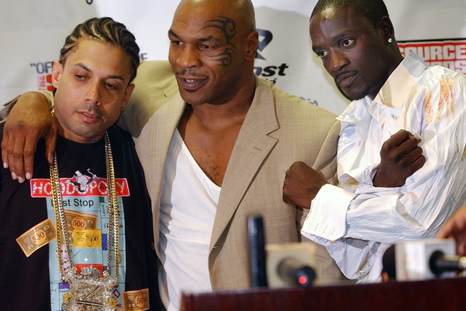 In this Oct. 10, 2004 file photo, Ray Benzino, left, from Source Magazine, Mike Tyson and Akon pose for a photo at the Source Hip Hop Awards ceremony in Miami. (AP Photo/J.Pat Carter)