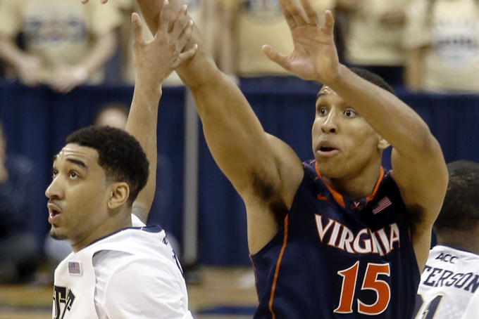 Virginia's Malcolm Brogdon (15) follows through on a 3-point basket over Pittsburgh's Cameron Wright in the second half of an NCAA college basketball game on Sunday, Feb. 2, 2014, in Pittsburgh. Virginia won 48-45. (AP Photo/Keith Srakocic)