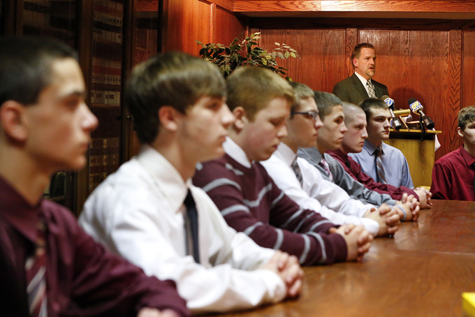 Philipsburg High School wrestlers, from left, Tyler Agans, Tylor Petchonka, Andrew Horun, Broderick Bupivi, Jimmy Schuitema, Tim Hinkle, Garrett Wolfinger, and Daniel Wissing, who were scratched from a state tournament days after a photo surfaced of team members apparently simulating a lynching, look on as their attorney, Scott Wilhelm, reads a statement on their behalf at a news conference on Thursday, Feb. 20, 2014 in Philipsburg, N.J. (AP Photo/Rich Schultz)