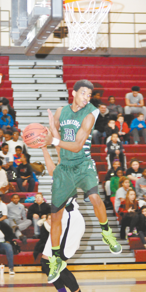 ALEX BELL of Allderdice hauls in a rebound in the Dragons 66-53 win over Obama Academy.  