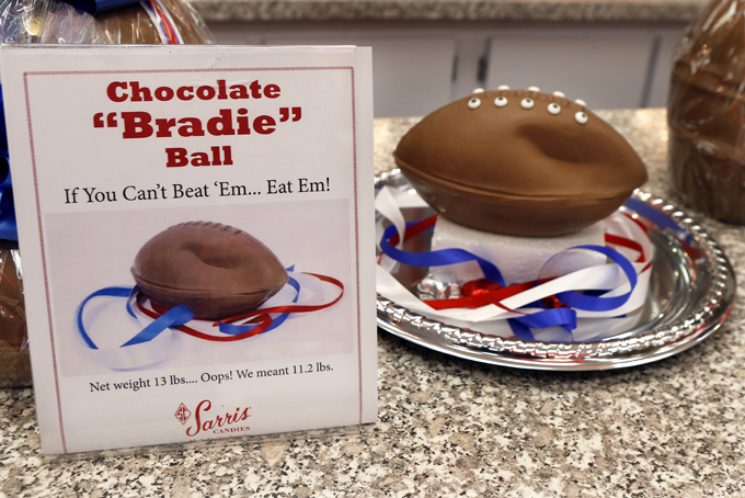 A "deflated" chocolate football called a "Bradie" Ball is on display at Sarris Candy store in in Canonsburg, Pa., on Wednesday, Jan. 28, 2015. Owner Bill Sarris says they came up with the idea to poke fun at the controversy surrounding under-inflated footballs on Tuesday.  The display item isn't for sale.  (AP Photo/Keith Srakocic))