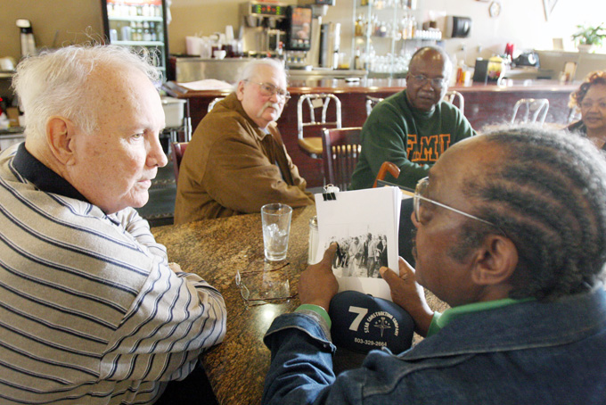 In this Jan. 23, 2009, file photo, Elwin Wilson, left, and Friendship 9 member Willie McCleod, right, look over pictures from civil rights incidents in Rock Hill, S.C., in the 1960s. The criminal record will soon be erased for the nine black men arrested for integrating a whites-only South Carolina lunch counter 54 years ago. On Wednesday, Jan. 28, 2015,  prosecutor is expected to ask a judge to vacate the arrests and convictions of the men known as the Friendship 9. (AP Photo/Herald, Andy Burriss, File)